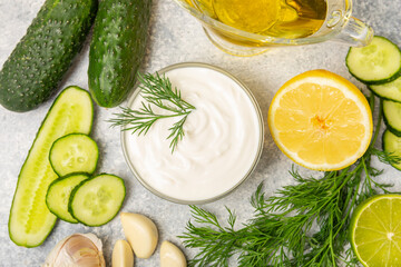 Cucumber sour cream tzatziki sauce on a wooden table.Tartar sauce. Traditional delicious appetizer....