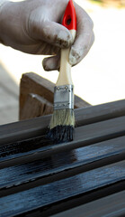 Painting Metal Surface with Brush and Protective Gloves