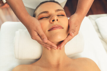 Caucasian woman enjoying relaxing anti-stress head massage and pampering facial beauty skin...