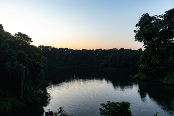 Boat reflection on still Kaptai Lake surface.