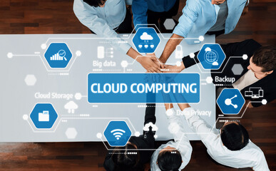 A diverse group of business professionals collaborates over cloud computing concepts, showcasing...