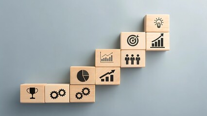 Wooden blocks with business icons arranged in a staircase showing growth and success