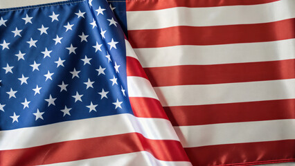 Fototapeta premium Close up view of American flag with stars and stripes, symbolizing patriotism and national pride. fabric texture is visible, highlighting vibrant red, white, and blue colors