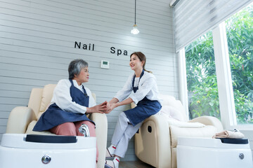 Asian mother and daughter embracing hands warmly preparing for grand opening day of new cozy small...
