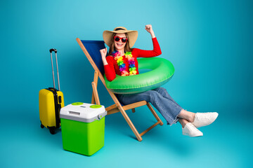 Pretty woman enjoying vacation vibes with colorful accessories on a vibrant background, surrounded...