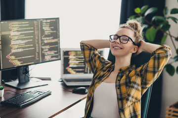 Professional female programmer working from home, enjoying a moment of relaxation in a modern...