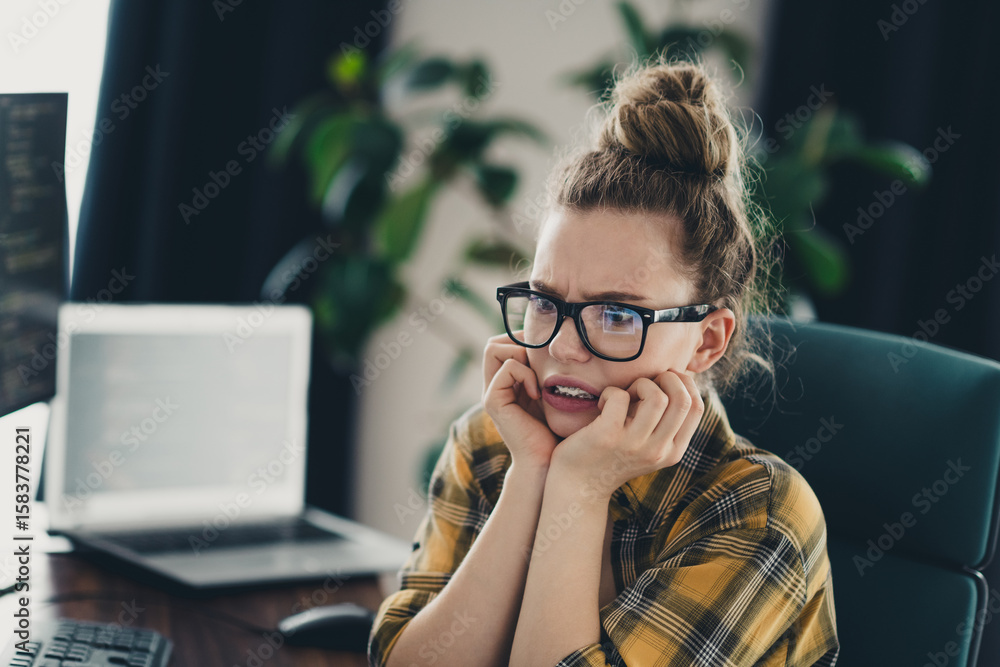 Poster worried woman looking concerned while working remotely from home on a programming project in a styli