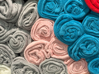 Fototapeta premium Rolled Towels in Multicolor Rows,Shelf Display with Soft Texture Harmony