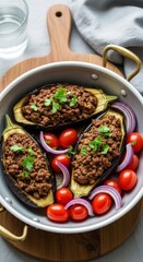 Three Stuffed Eggplant Halves with Ground Meat Topping Cherry Tomatoes and Red Onion Slices minced meat