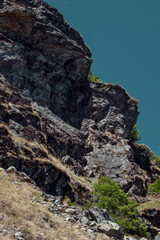 Stone and Sky. Edge of the Slope, Touching the Sky. Where Earth Falls Away into Blue. Cracks, Shadows, and Silence on the Mountain Side