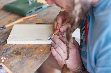 A man carving wood with chisels. Creativity, hobby