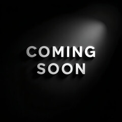 Fototapeta premium Metallic Coming Soon text mounted on a dark wall illuminated by a single spotlight creates anticipation for launch.