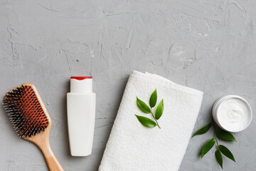 cosmetic for hair care, cream and towel on a colored background top view. flat lay