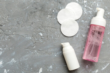 Micellar cleansing water and discs to remove cosmetics and cleanse the skin on colored background....