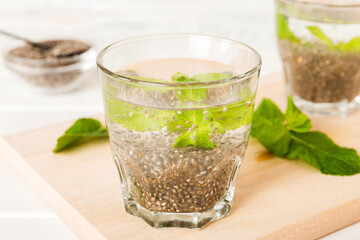 Healthy breakfast or morning with chia seeds and mint on table background, vegetarian food, diet and health concept. Chia pudding with and mint