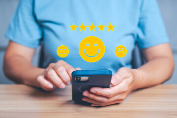Customer giving a five-star rating for a satisfaction survey on a smartphone. Best service evaluation. Positive feedback and high-quality rating for a product or service.