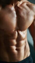 Fototapeta premium Close-up of a person is toned stomach with visible abs, result of consistent training. Dedication, achievement. Defined, strong.