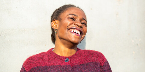 African woman laughing joyfully in bright natural light