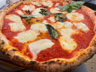 Close-up of a traditional Neapolitan pizza served on a ceramic plate