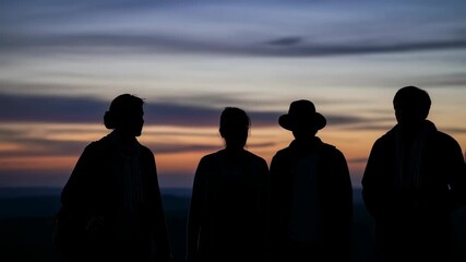 Silhouettes of weary travelers at sunset reflecting the arduous journey
