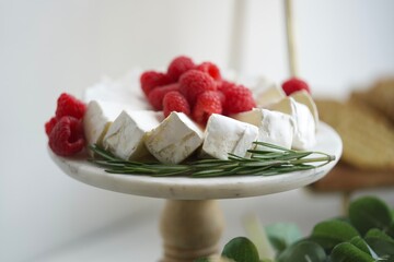 Cheese plate with raspberries 
