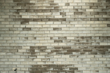 Textured concrete wall with varied tones and patterns from natural weathering and stains