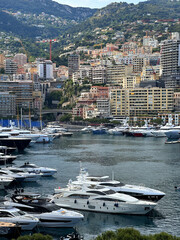 Scenic harbor view featuring luxury yachts anchored in calm waters, surrounded by vibrant cityscape...