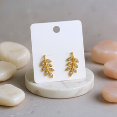 White earring cartouche on a stone with several flat stones around it