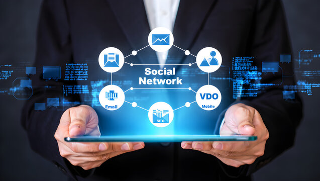 Digital social network concept glows on a tablet held by a businessperson, displaying email, seo, mobile connections and data.