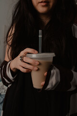 Young Woman Holding Iced Coffee Indoors