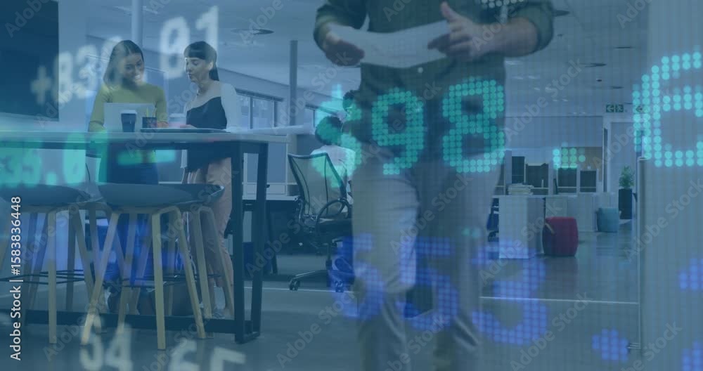 Poster when man walking through shot pair reviewing files at high table with finance charts scrolling