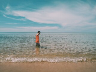 Boy Looking Out at the Sunny Ocean Horizon