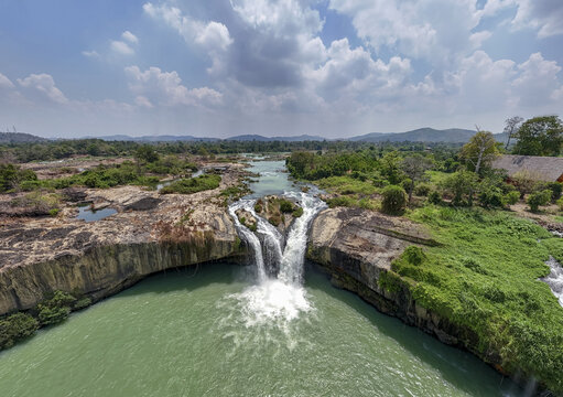 Aerial view of the dramatic cascade of Dray Nur Waterfall plunging into the river amidst lush greenery, Buon Ma Thuot, Dak Lak, Vietnam.
