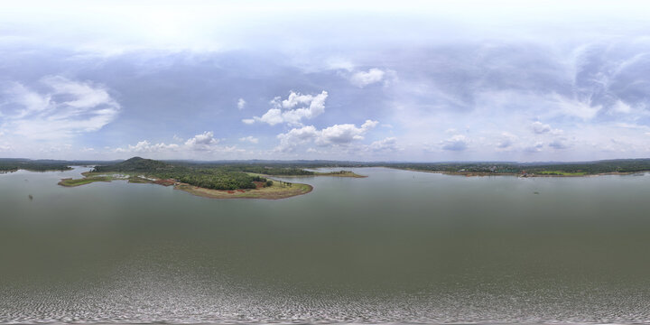 Aerial view of verdant islands and peninsulas nestled in the still, reflective waters under a vast sky, Dak Lak Province, Buon Ma Thuot, Vietnam.