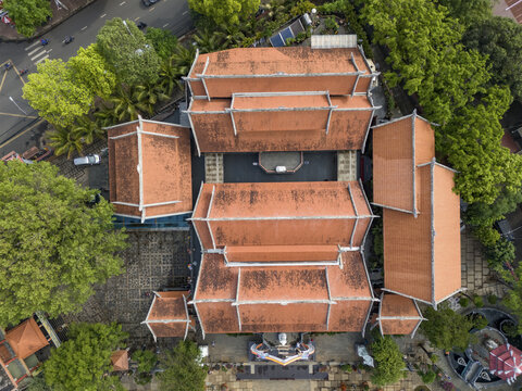 Aerial view of Dak Lak Museum's orange-tiled roofs and lush green trees create a vibrant contrast, a cultural gem from above, Buon Ma Thuot, Dak Lak, Vietnam.
