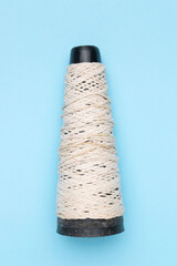 Cone of White String Against Sky Blue Background for Craft or Textile Projects