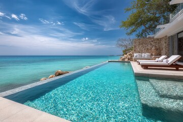 Fototapeta premium Luxury infinity pool invites relaxation with panoramic ocean bay views at a serene seaside retreat in late afternoon sunlight