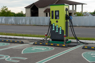 Electric vehicle charging station located near a construction site in a serene suburban area during...
