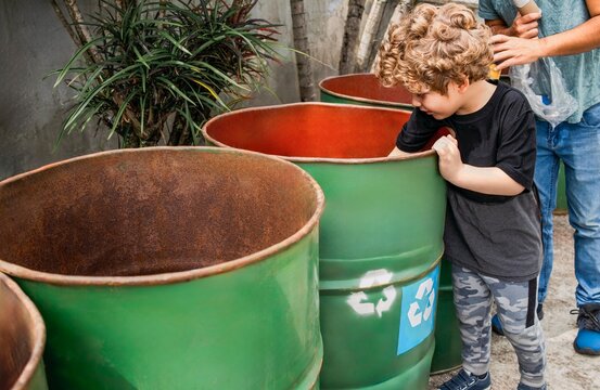 Father and son recycling together in the backyard