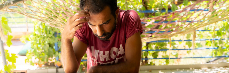 man deep in thought on vacation
