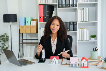 Confident American woman real estate agent stands proudly outside a modern home, radiating...