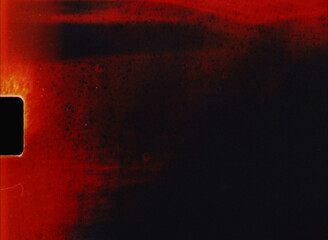 Old 8mm film burning showing light leaks, grain, and scratches as a textured background