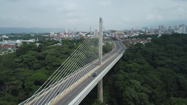 Aerial view of the Viaducto Provincial in Bucaramanga, Colombia. A modern bridge connecting the city, with visible traffic and contemporary architecture, surrounded by urban and mountainous landscape.