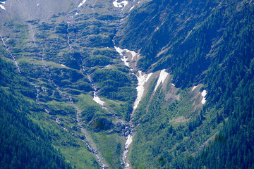 Scenic view of mountain panorama in the Swiss Alps seen from Lauchernalp hiking trail on a sunny...