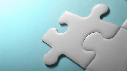 Obraz premium Two White Puzzle Pieces Interlocking on Blue Background – Concept of Connection, Problem Solving, and Strategic Fit