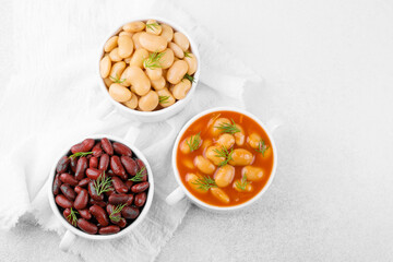 Kidney, butter and baked beans in bowls on towel for protein food, clean eating or vegan variety concept