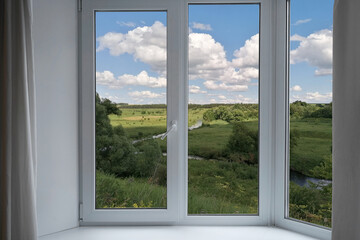  View from the window of green hills and gardens.  