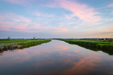Scenic minimalist view of reflection of clouds in the river Rotte, north of Rotterdam, The...