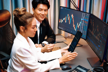 Businesswoman holding tablet on dynamic stock exchange statistic online showing to partners to...