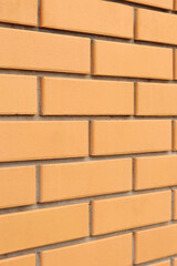 Brick wall side view background. Orange brick wall background for exterior design. Construction...